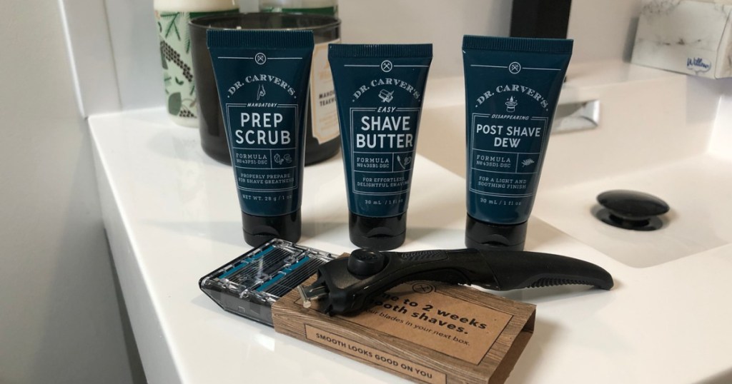 bathroom counter with razor and bottles of after shave on it