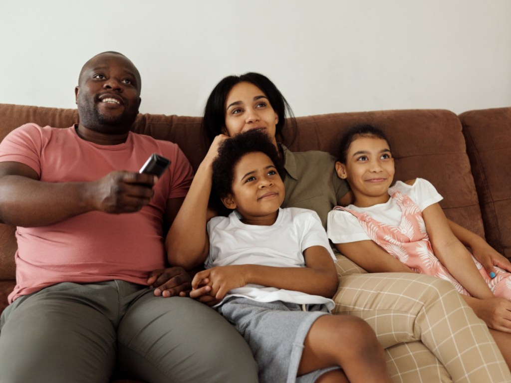 family on couch watching tv together