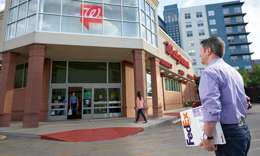 man walking into walgreens with his fedex package