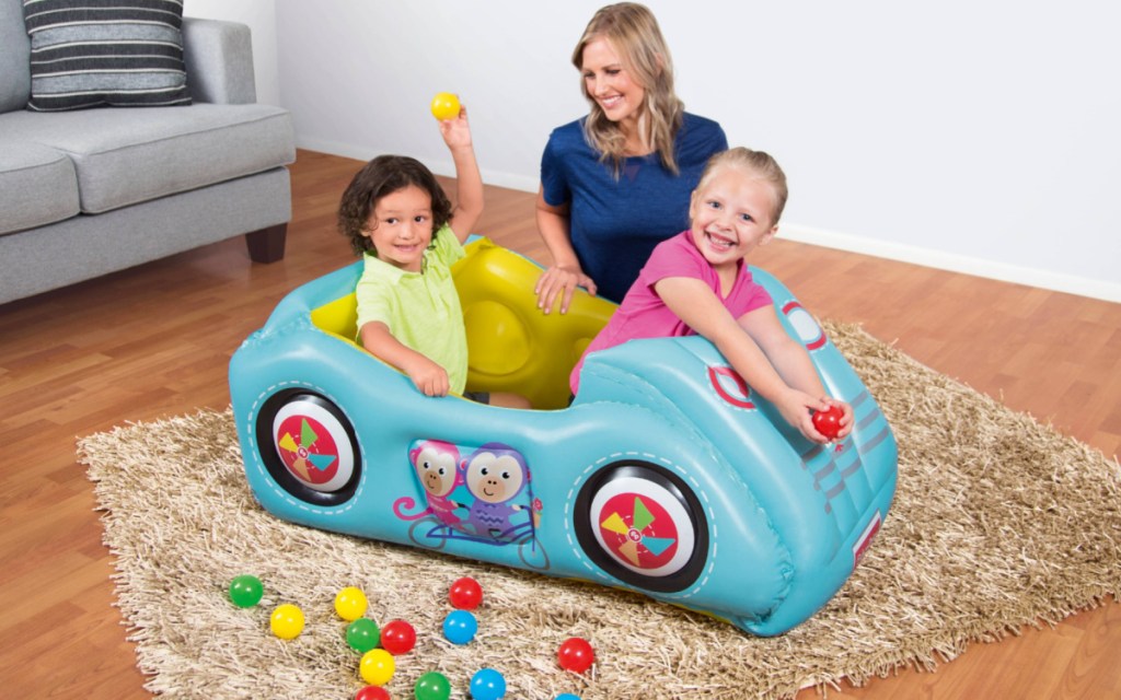 kids playing in fisher price race car ball pit