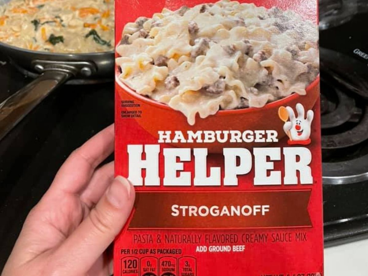 hand holding up a box of hamburger helper