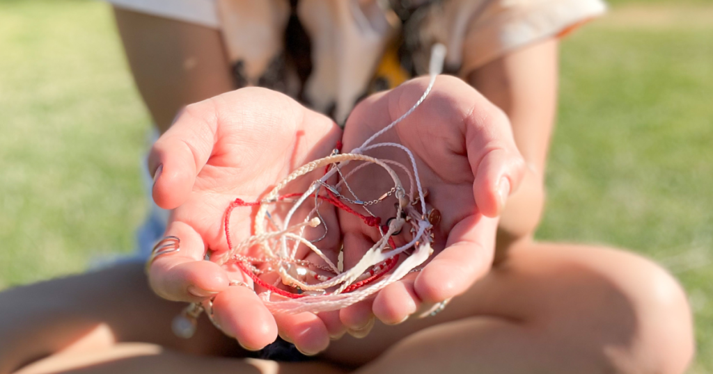 hand holding friendship bracelets