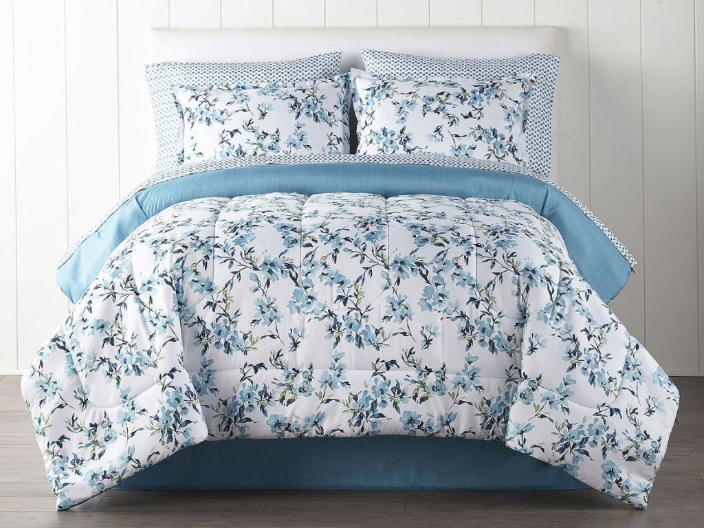 blue and white floral comforter set on bed