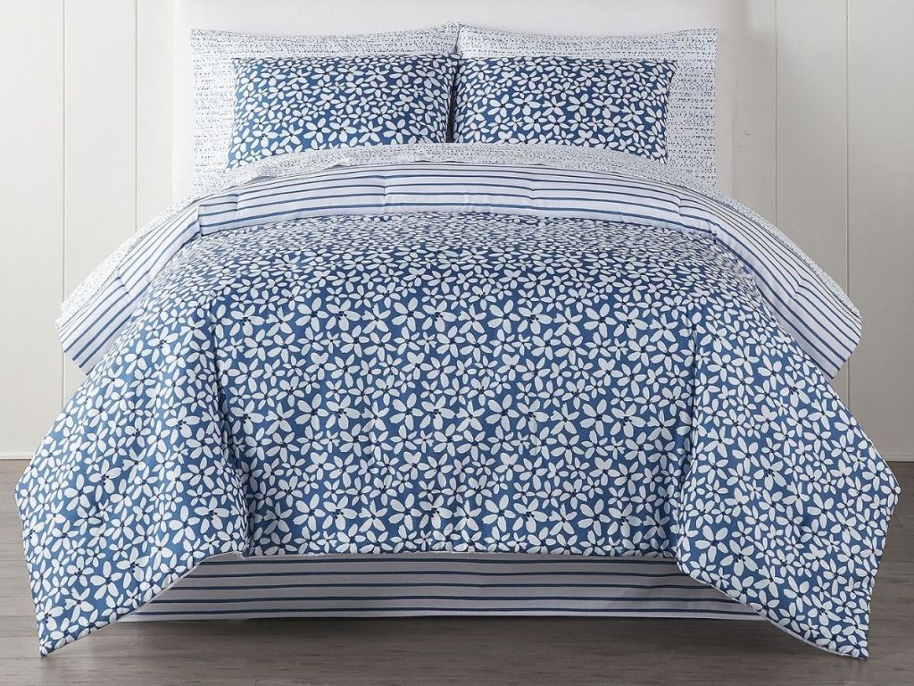 blue and white flower comforter set on bed