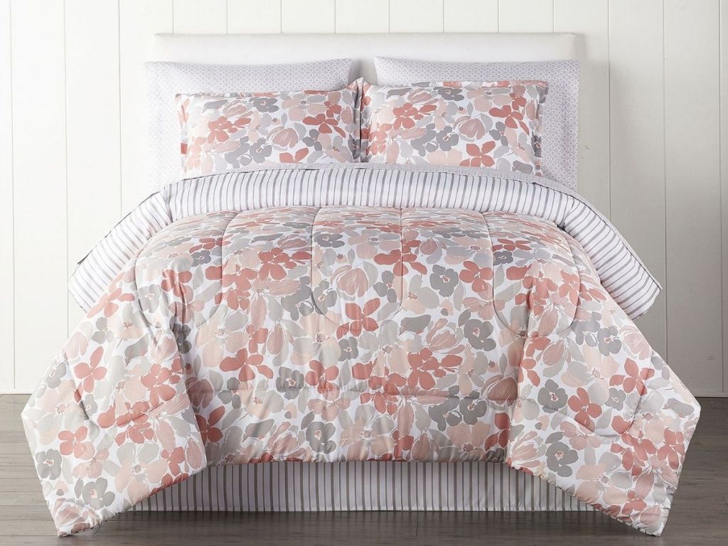 pink themed floral comforter set on bed