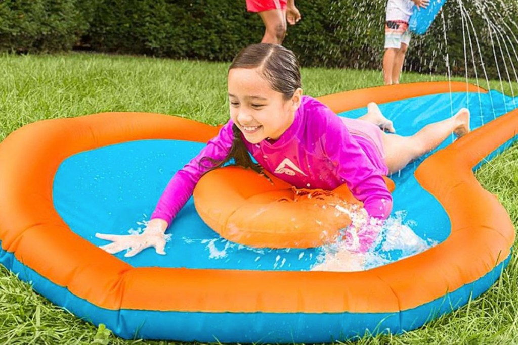 girl playing on kids water slide