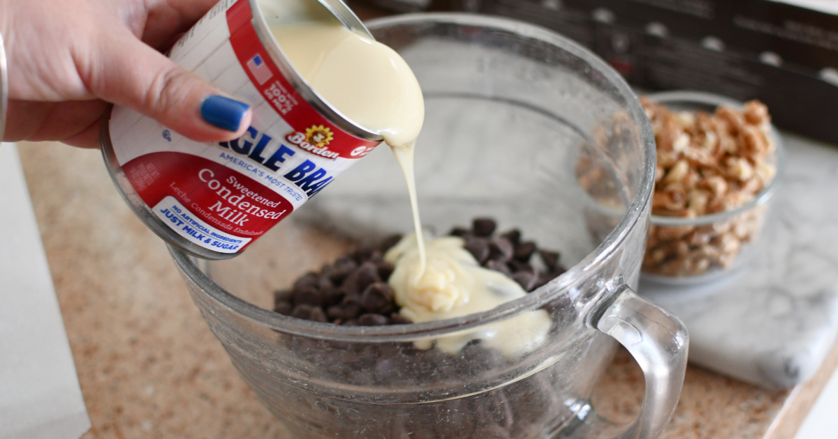 pouring sweetened condensed milk into chocolate chips