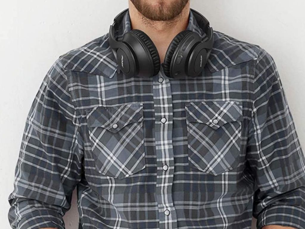 man wearing mpow black headphones around his neck