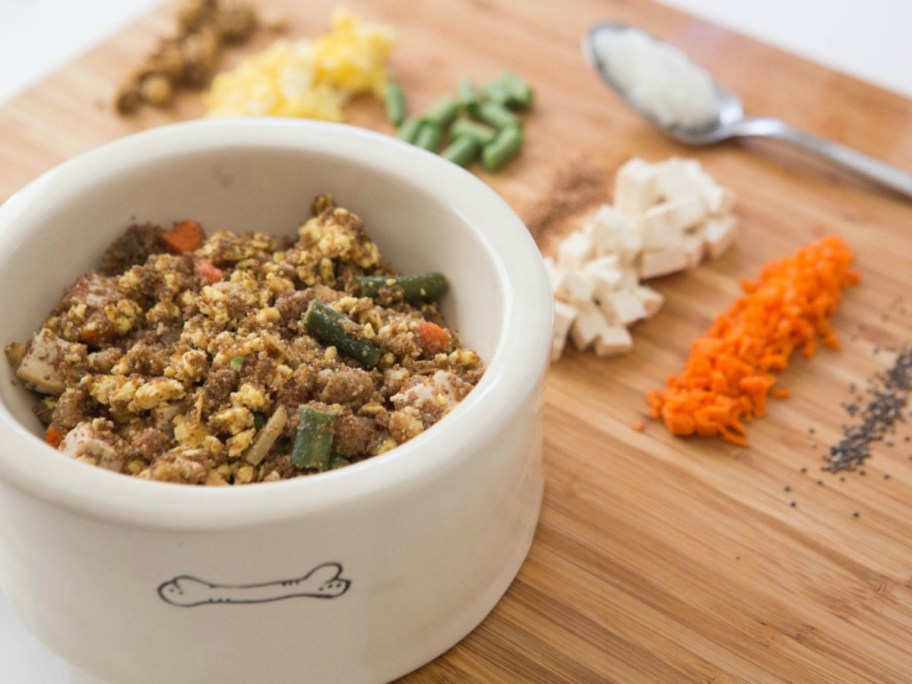 close up of bowl bowl with chopped fresh ingredients in background