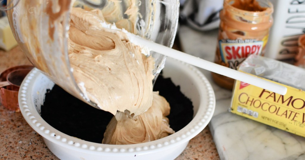 pouring peanut butter pie in pie pan