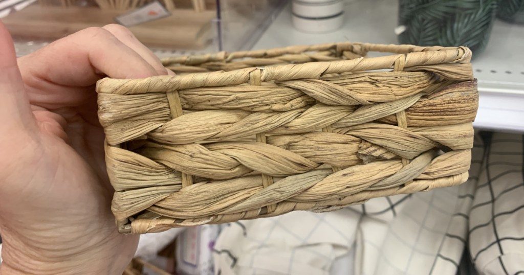 small wicker basket in hand in store at target