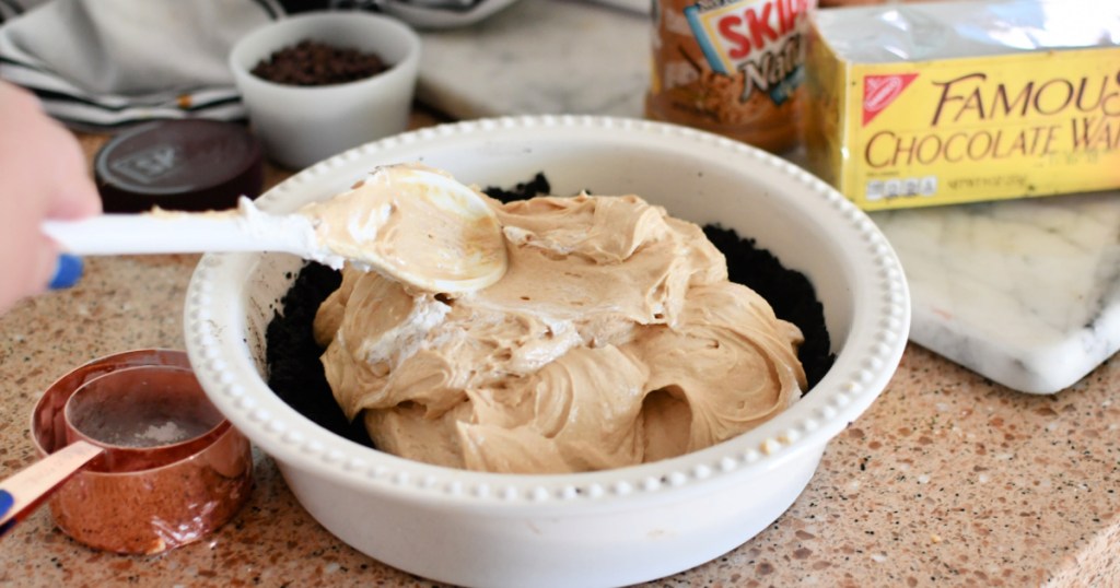 smoothing out peanut butter pie filling
