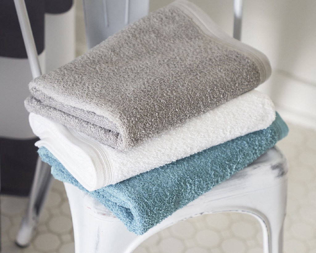stacked bath towels on chair
