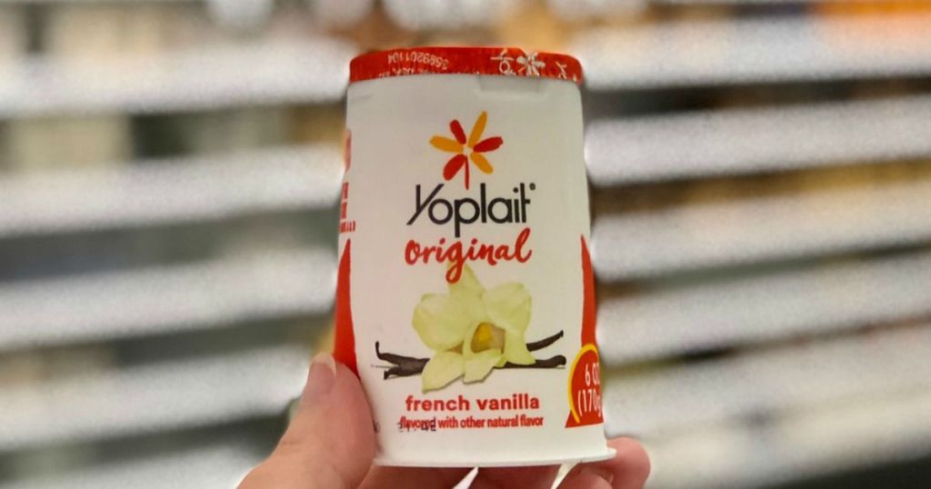 holding a cup of Yoplait yogurt