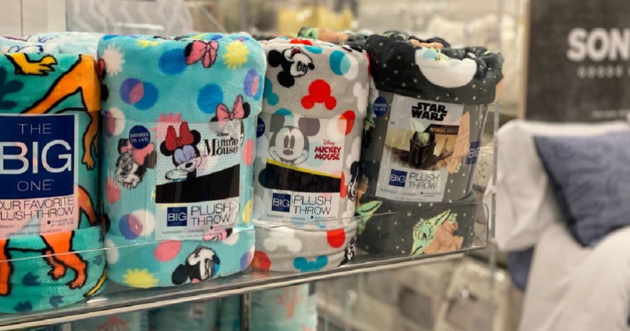 Mickey and Star Wars blankets on a store shelf.
