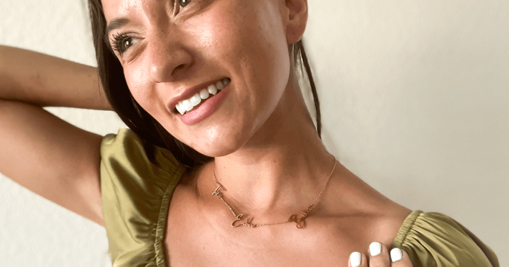 woman showing off name necklace 