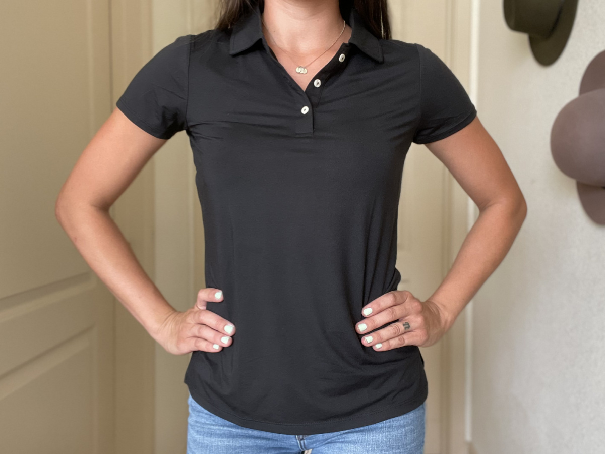 woman wearing a black short sleeve polo top