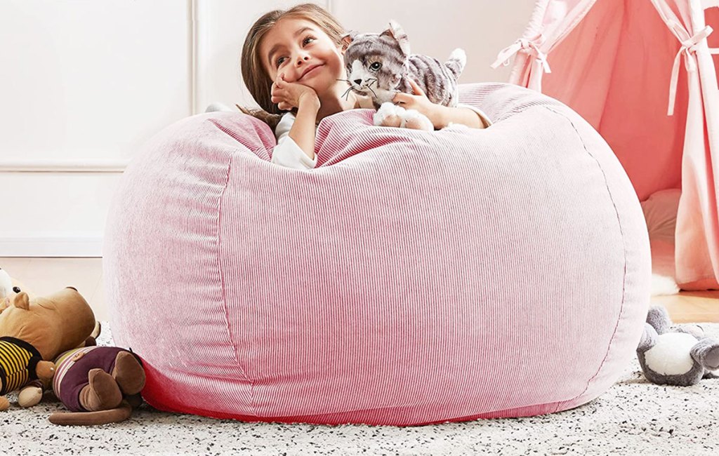 girl laying on pink bean bag chair