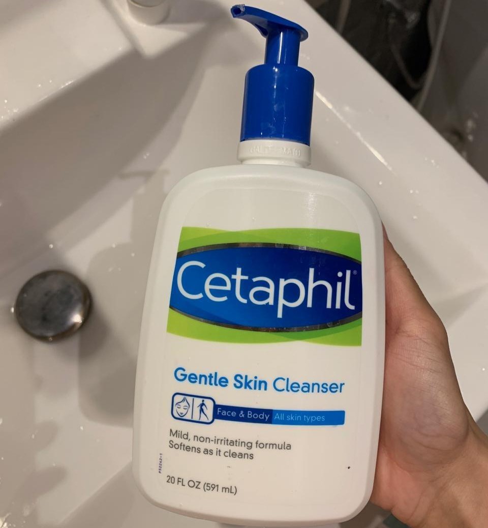 hand holding a bottle of Cetaphil