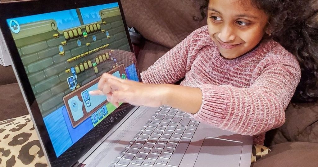 girl pointing to a computer