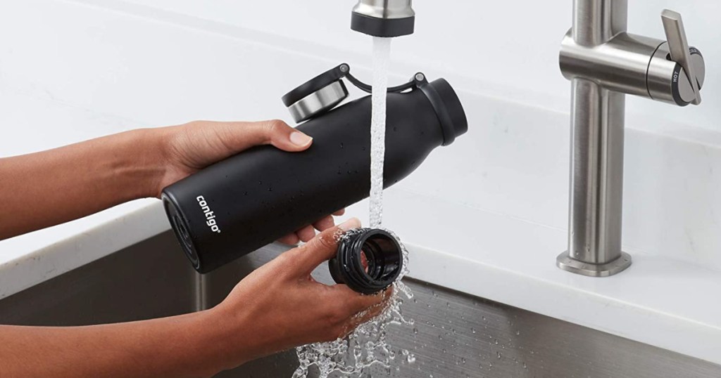 hands washing black insulated water bottle
