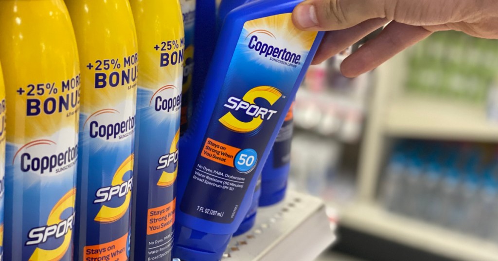 hand holding sunscreen coppertone