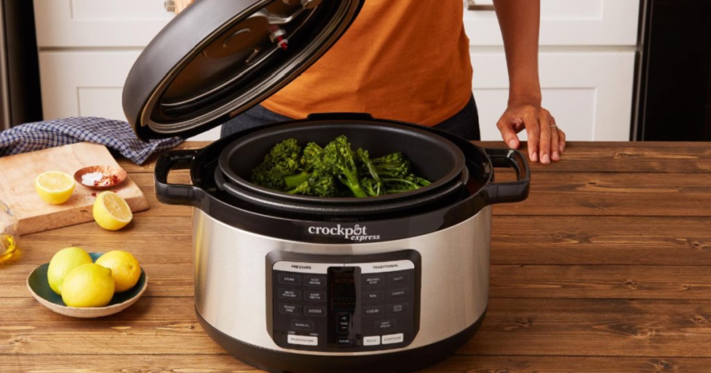 person placing a lid on a crock pot pressure cooker