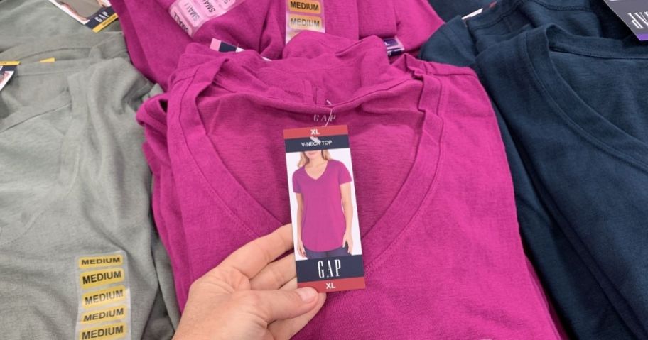 hand holding the tag on a t-shirt