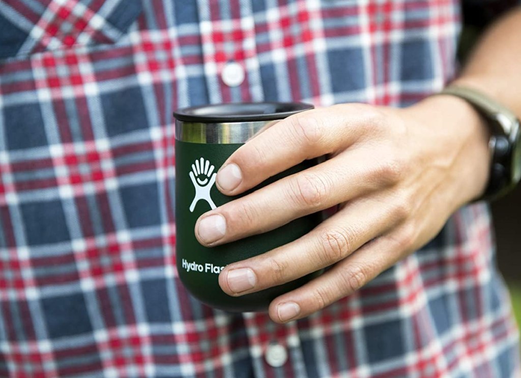 man's hnd holding olive green hydro flask wine tumbler
