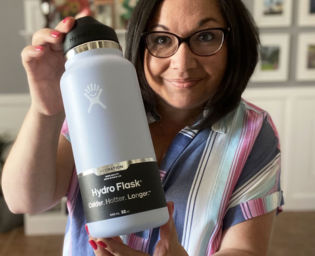 woman holding up lilac colored hydro flask bottle