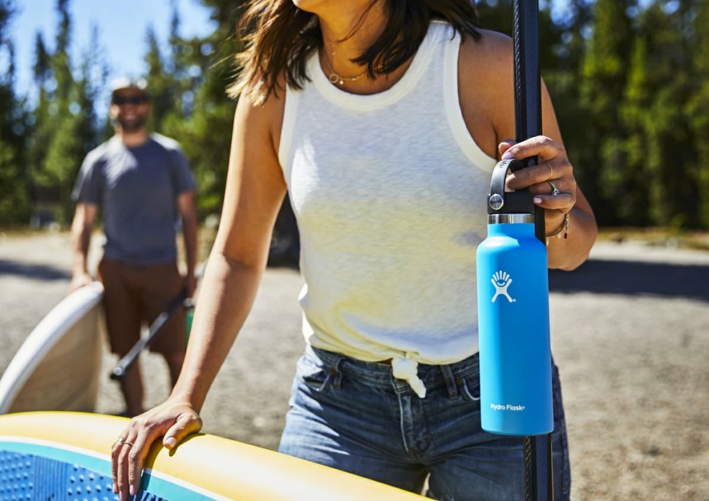 woman holding blue hydro flask bottle