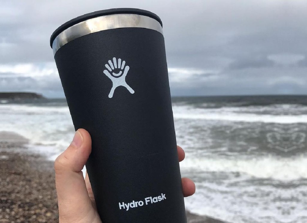 hand holding a black hydro flask tumbler