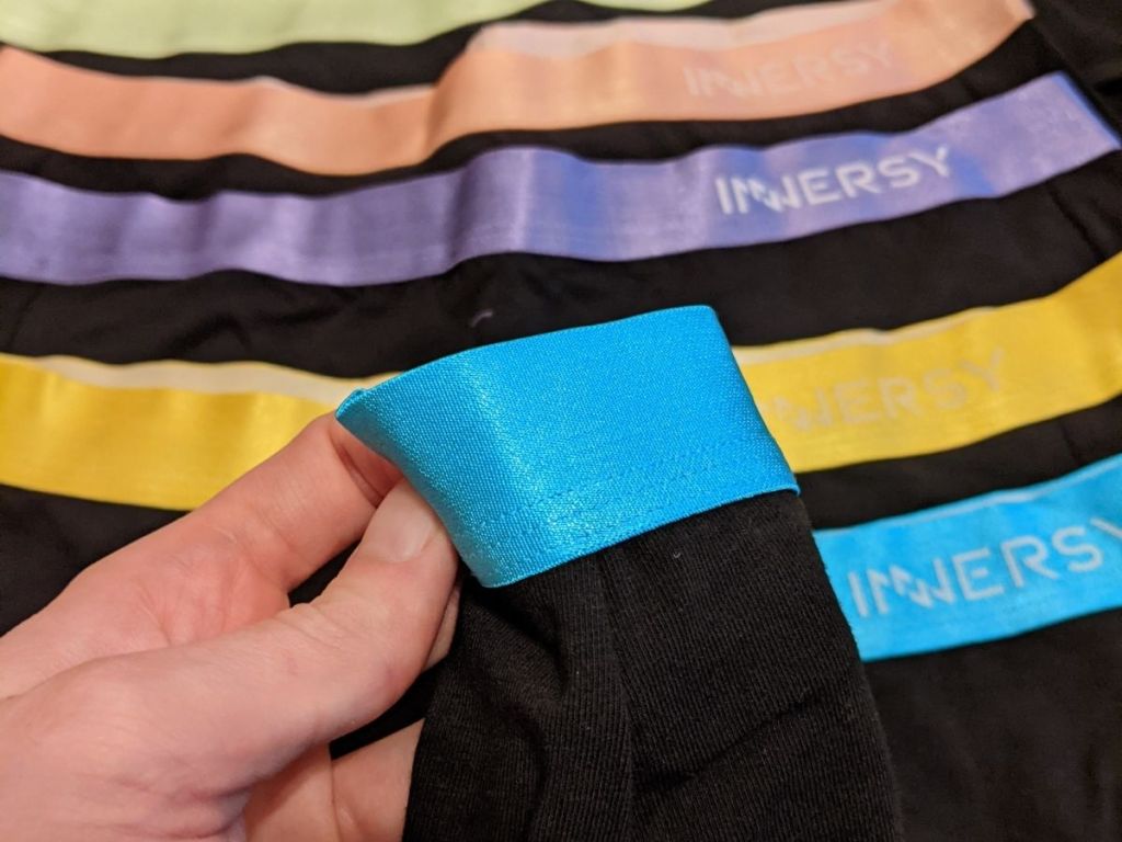 woman holding close up of waistband on innersy women's undies 
