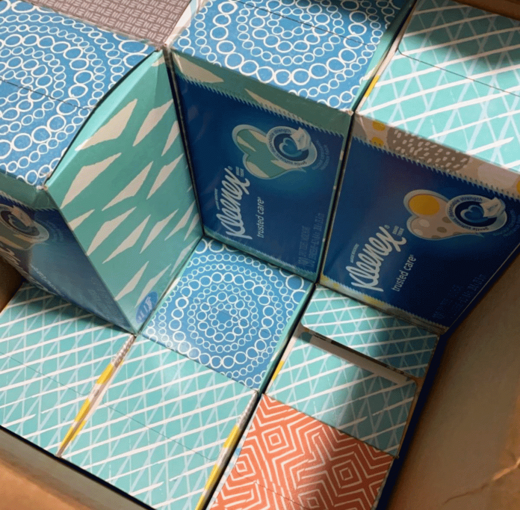 multiple boxes of kleenex tissues in shipping box
