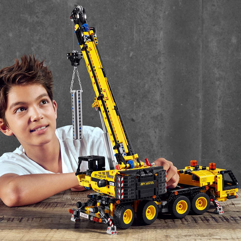 boy playing with a LEGO crane