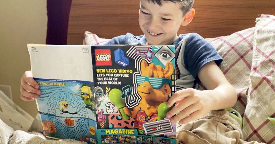 boy in bed reading lego magazine