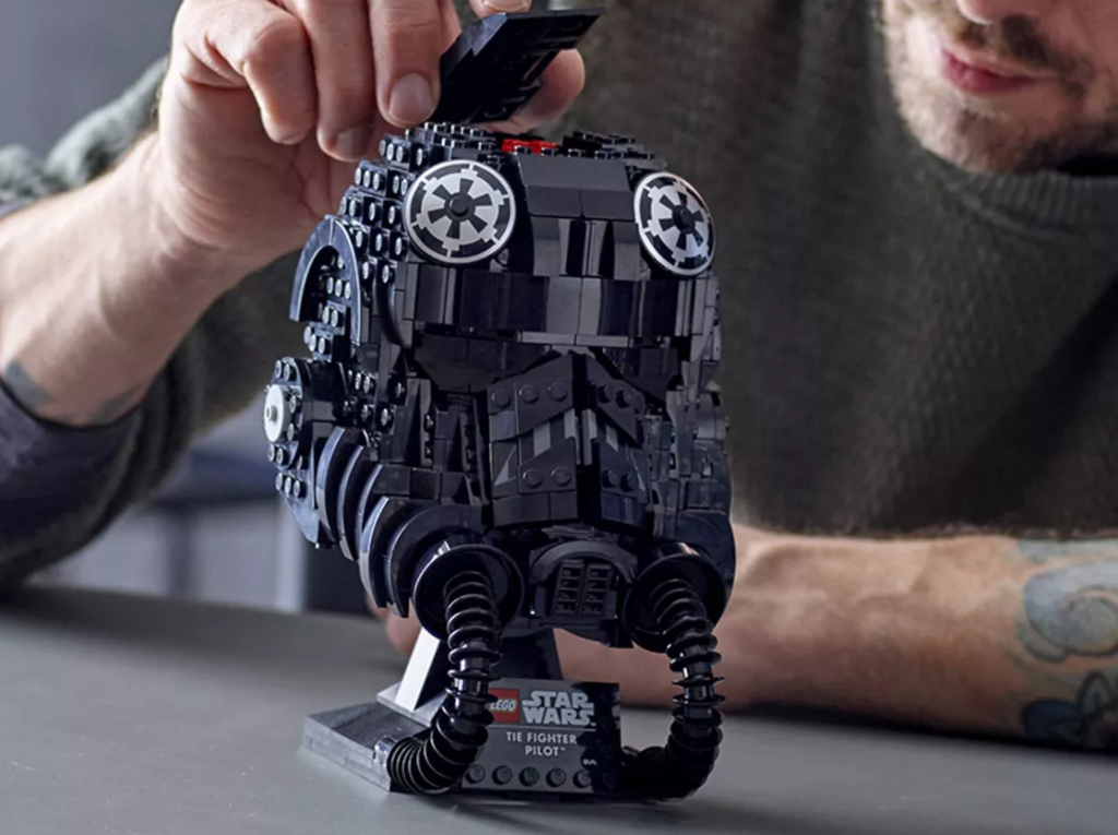 man putting together a LEGO Star Wars set