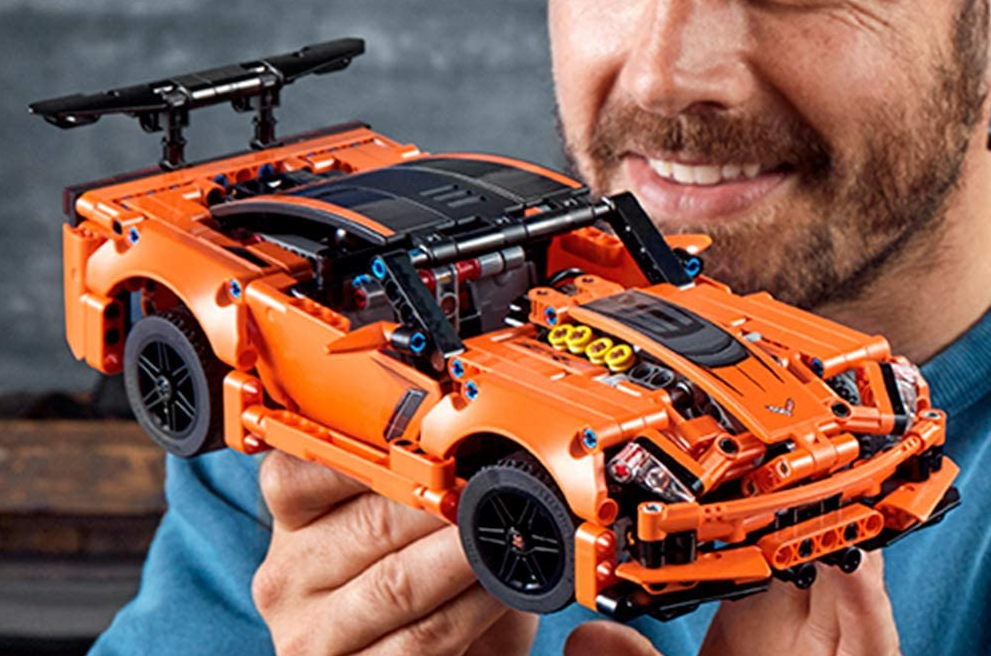 man looking at a LEGO Corvette