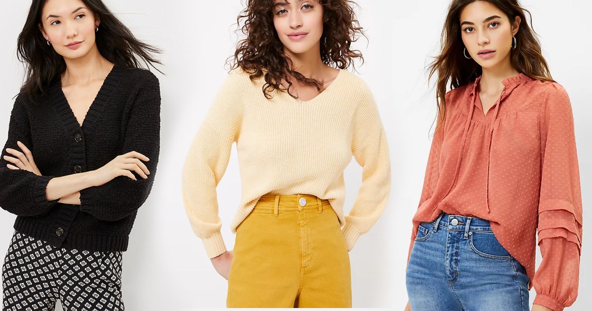 Three women wearing sweaters