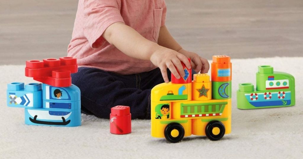 boy playing with toy building blocks
