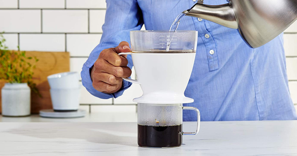 man using pour-over coffee system