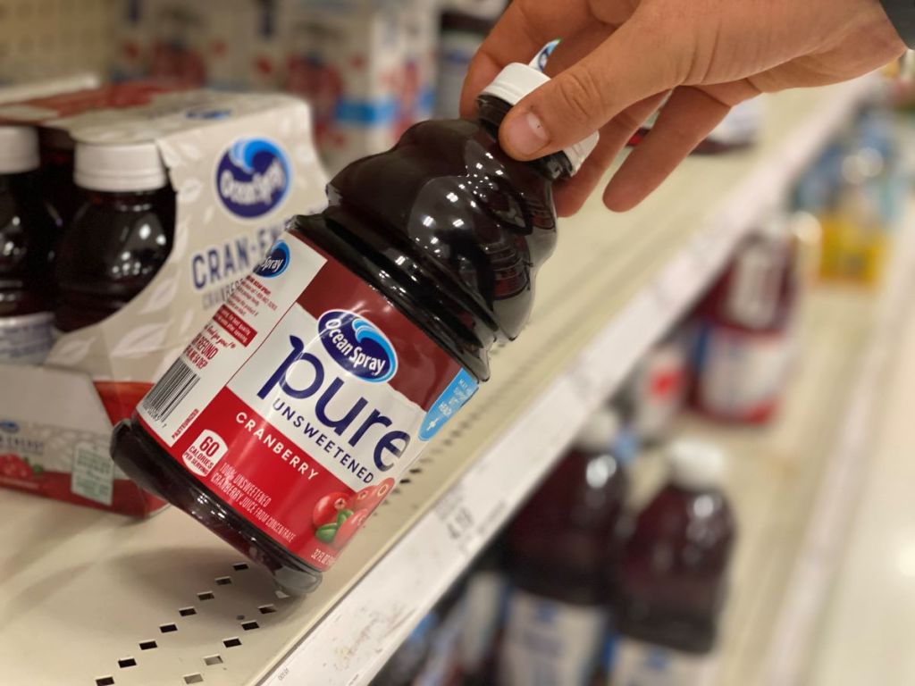 hand holding a bottle of Ocean Spray Pure Juice