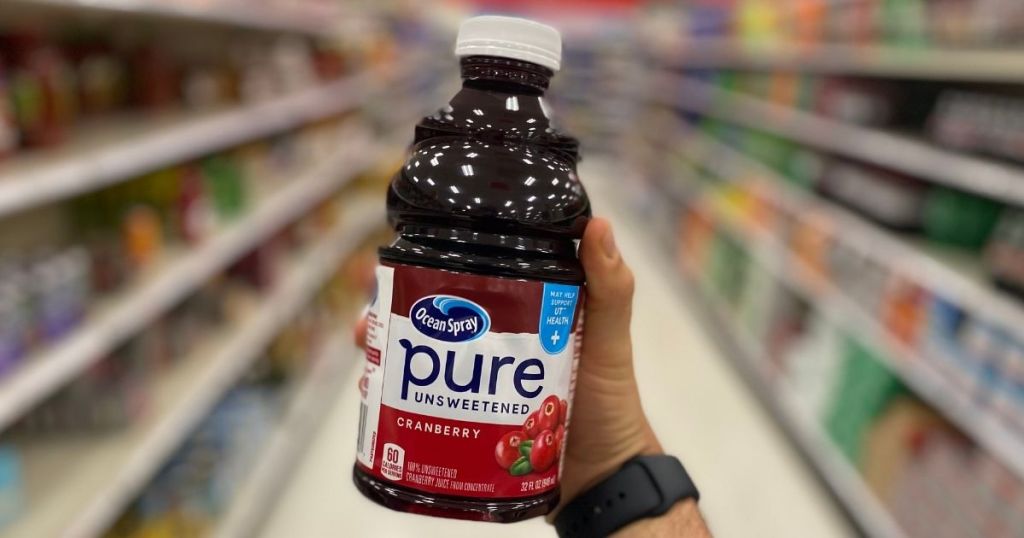 hand holding a bottle of Ocean Spray Pure juice