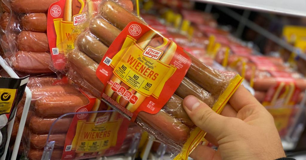 hand holding package of hot dogs 