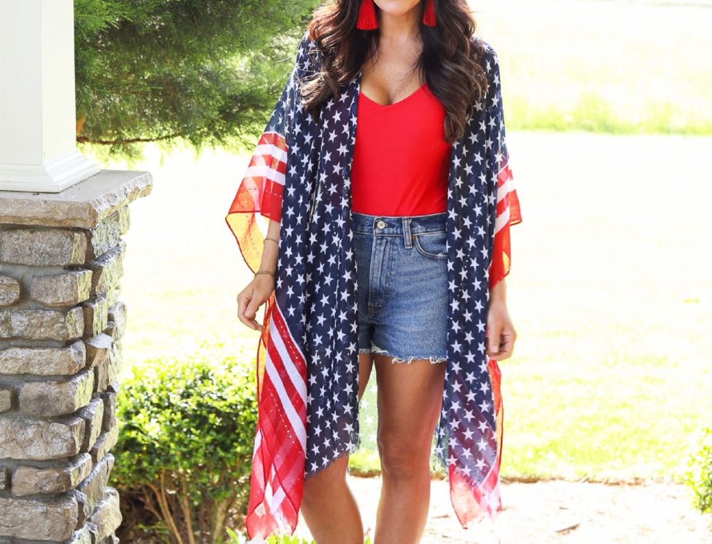 woman in red tank, jean shorts, and patriotic kimono