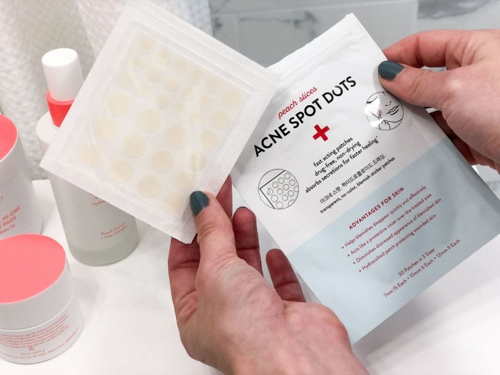 hand holding acne spots dots package and sheet