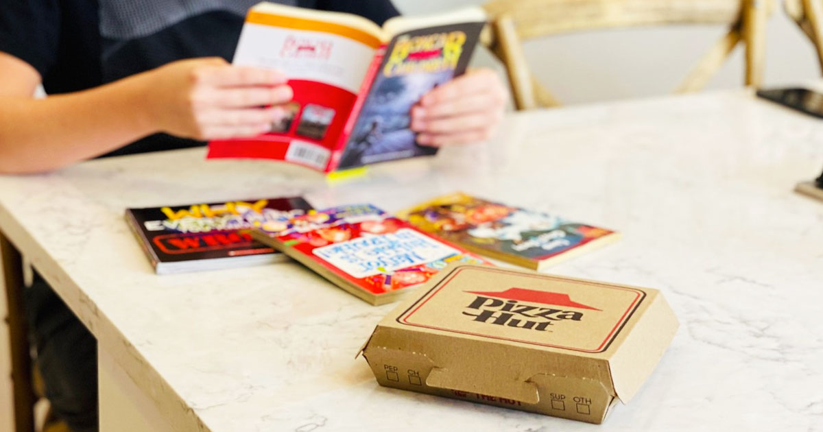 pizza hut box and books on kitchen counter