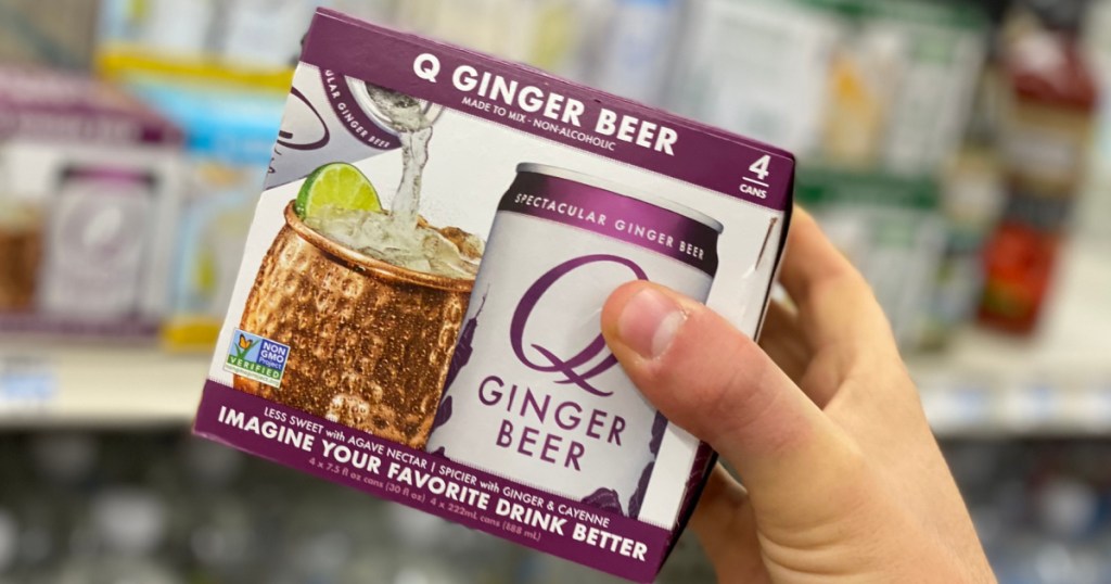 Hand holding 4 pack of ginger beer