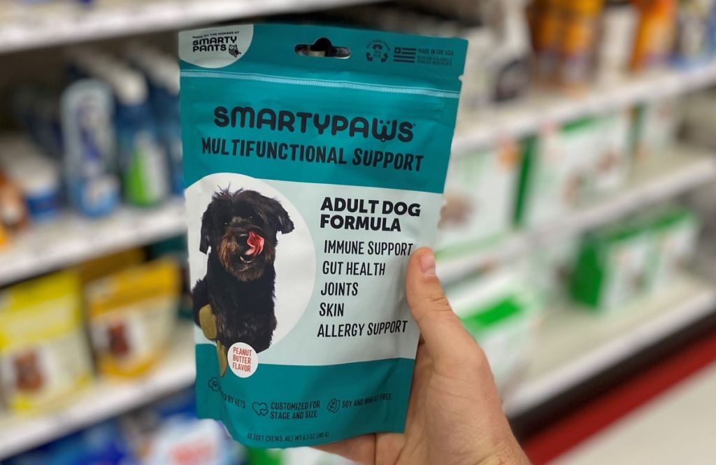 hand holding a bag of SmartyPaws Adult Supplements