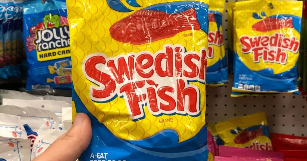hand holding a bag of Swedish Fish